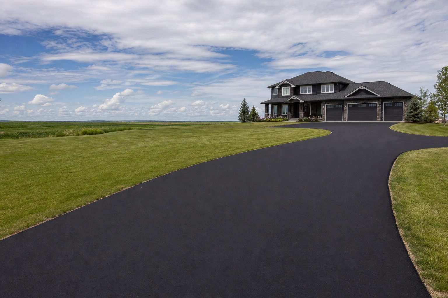 Freshly paved asphalt driveway at a Saskatoon home